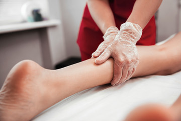 Massage of female feet in a beauty salon close up