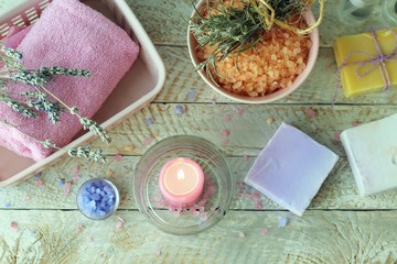 Spa, soap, burning candle, basket with towel and spray on wooden table, cleanliness and hygiene concept, natural home cosmetics, healthy lifestyle