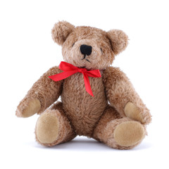 Teddy bear with red ribbon sitting on white