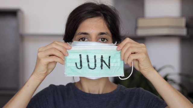 Female taking of masks that use to protecting from corona virus. Covid 19 virus last whole year 2020 and make people depressed and exhausted.