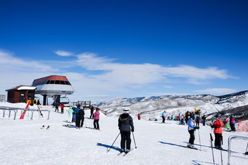 People starting to decide which slope to go down at the top of the gondola lift on this ski mountain. © Guntherize