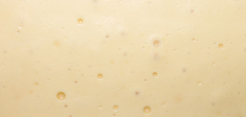 The smooth texture of the white creamy chocolate.White chocolate background.