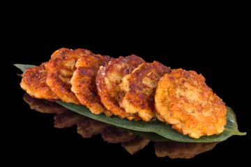 Delicious salmon balls with reflection, isolated on black background