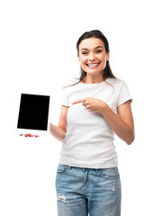 young woman in white t-shirt pointing with finger at digital tablet with blank screen isolated on white