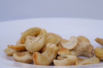 Roasted cashew nuts on white background.
