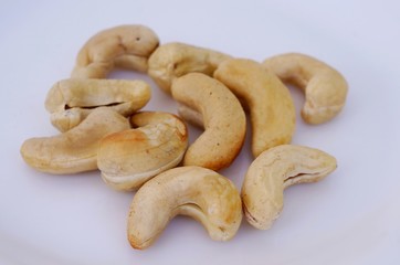 Cashew nuts on white plate. Roasted cashew nuts.

