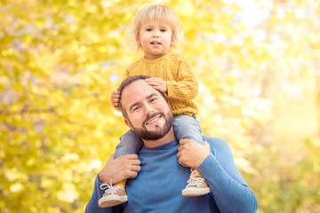 Happy family having fun outdoor in autumn park