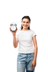 young brunette woman in white t-shirt and jeans holding retro alarm clock isolated on white
