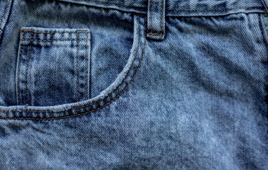 Details of denim trousers. Pockets and seams on denim.Old blue denim.The texture of the fibers of...