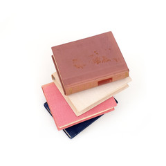 Stack of books in colour covers with white sheets isolated on a white background