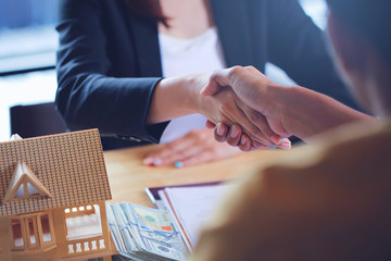 The hands of the businessman and his customers who are shaking hands congratulate. Because the housing loan agreement was approved.
