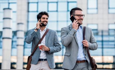 Business people makes a phone call in front of the corporation. Business, lifestyle concept