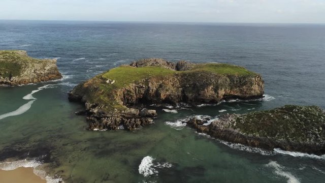 Cliffs in Asturias. Coastal landscape in Cue, beach of Llanes. Spain. Aerial Drone Footage