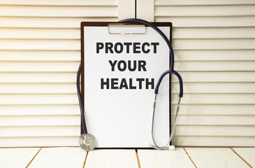 Protect your health concept. Physician shows a message on a signboard in his hands