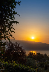 Sunrise in Manerba del Garda with the silhouettes of the mountains in the background on Lake Garda, Italy