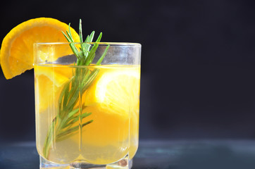 glasses of honey bourbon cocktail with rosemary whiskey sour drink with orange peel, or winter warmer drink punch or mulled wine christmas party cocktail or detox, healthy drink for diet, vitamin c