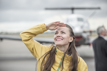 Young woman in front of the airplane