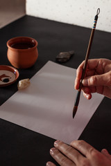 Calligraphy master work table with paper and pen