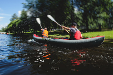 A process of kayaking in the city river canals, with colorful canoe kayak boat paddling, process of canoeing, group of kayaks