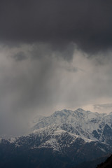 Rain clouds over the snowy Himalayan mountains