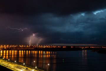 Fototapeta na wymiar lightning over the river