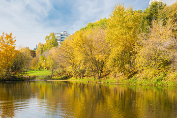 Colorful trees and pond in autumn, Narodnyy Park, Central Chertanovo, Moscow, Russia