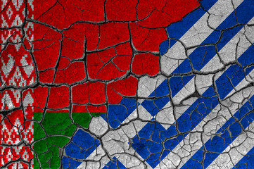 Flags of Belarus and Greece on a cracked wall, dry land. Concept of relationship or conflict between countries	