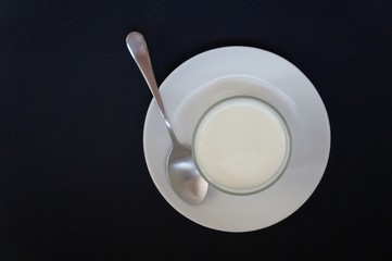 Top view of Yogurt on a glass with a spoon. Healthy food concept.
