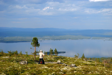 A man looking at the Tolvand lake from the height