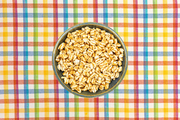 Honey puffed wheat in a bowl on a placemat