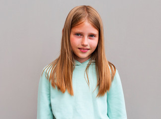 Fototapeta premium Portrait of beautiful blonde girl smiling looking at camera