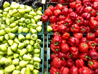 Ripe red and green peppers in a box. Fresh bell peppers in a box