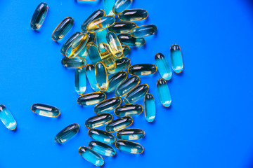 Fish oil capsules on a uniform background.