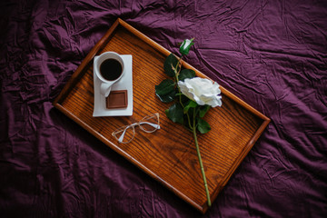 Morning coffee in bed with a flower