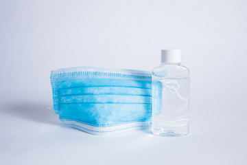 medical masks with transparent hand sanitizer on a white background with space for text
