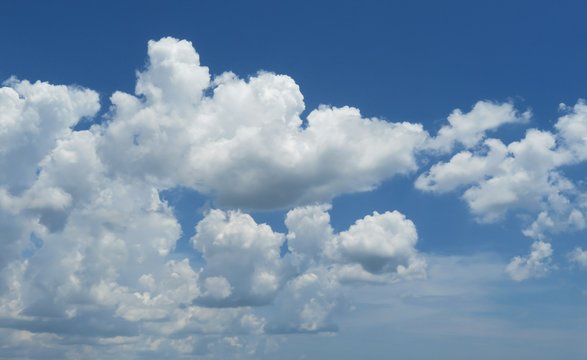 Beautiful fluffy cumulus clouds in blue sky, natural clouds background 