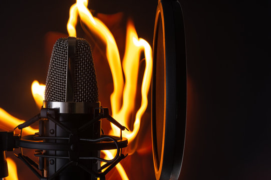 Black Professional Studio Microphone On Fire Background, Recording Vocals Or Sound