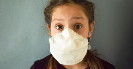 Beautiful girl in a medical mask against bacteria and viruses.