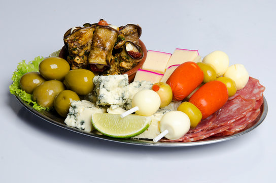 Portion of cold cuts, olives, gorgonzola cheese, pickled sausage, and salami