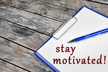 Stay motivated words on white paper