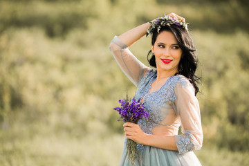 Fototapeta na wymiar beautiful young female with makeup and hairstyle, with a bouquet of flowers