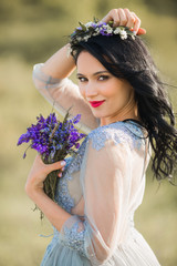Naklejka premium beautiful young female with makeup and hairstyle, with a bouquet of flowers