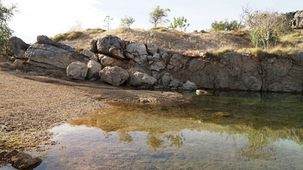 Fototapeta na wymiar Pond lake situated in lush landscape at Boab Quarry Campsite in Western Australia.