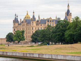 Schwerin castle in summer with overcast sky and calm water