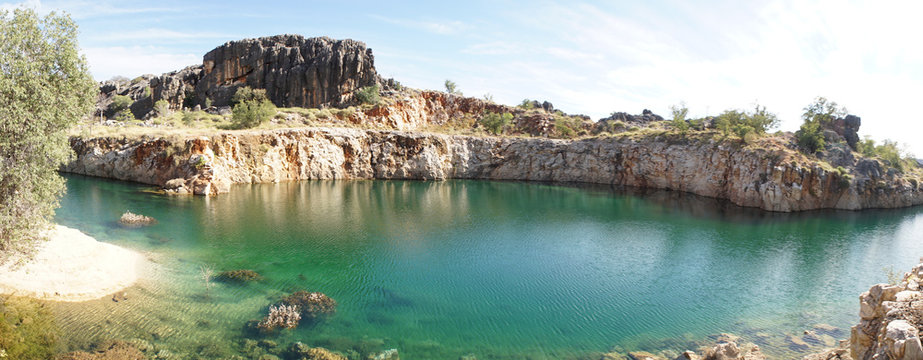 Pond lake situated in lush landscape at Boab Quarry Campsite in Western Australia.