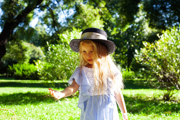 little cute blond girl outside having fun on picnic, lifestyle people concept