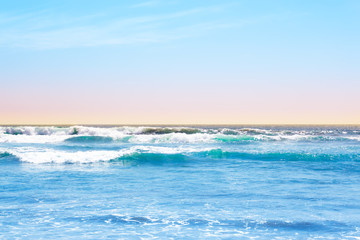 Blue ocean waves and yellow sand