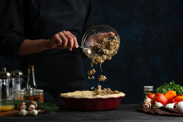 Chef making meat and mushroom pie, freeze in motion, cooking and recipe book, food preparation