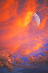 Sunset Clouds & Moon -- Setting sun has given the cloud formation a temporary and fleeting...