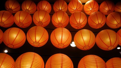 A round of beautiful Chinese lanterns hanging on a wire and glowing in the dark night for A new year festival 